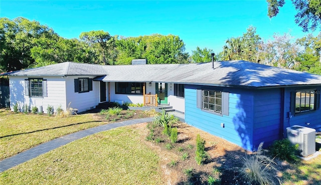 ranch-style home with covered porch, a front yard, and cooling unit