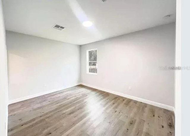 empty room with wood-type flooring