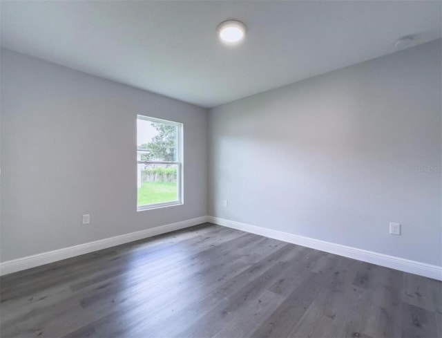 unfurnished room with dark hardwood / wood-style floors