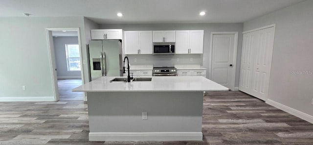 1030 Darlington Ct, Kissimmee, FL 34758 - kitchen featuring stainless steel appliances, dark wood-style floors, an island with sink, recessed lighting, and white cabinets