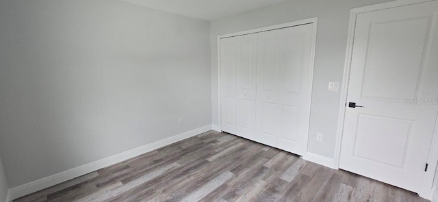 1030 Darlington Ct, Kissimmee, FL 34758 - unfurnished bedroom with a closet and wood finished floors