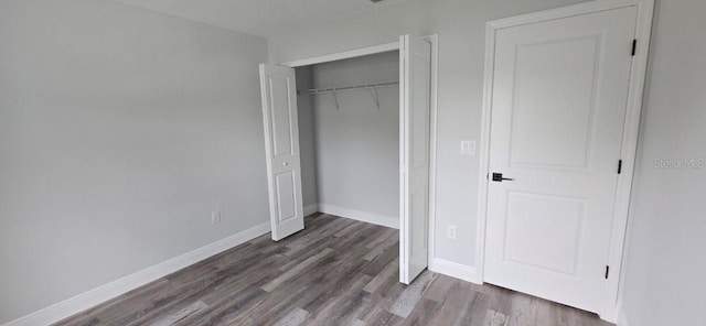 1030 Darlington Ct, Kissimmee, FL 34758 - unfurnished bedroom with wood finished floors and a closet