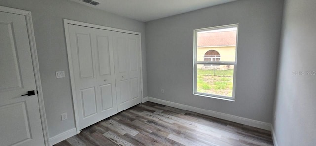1030 Darlington Ct, Kissimmee, FL 34758 - unfurnished bedroom featuring a closet and wood finished floors