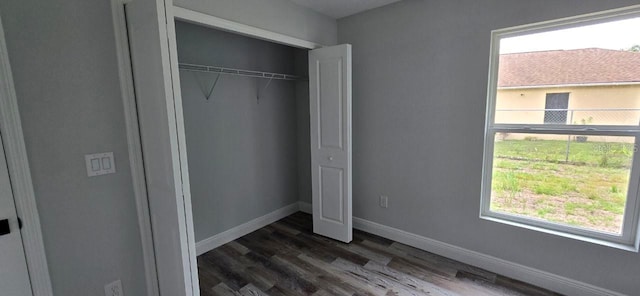 1030 Darlington Ct, Kissimmee, FL 34758 - unfurnished bedroom with dark wood-type flooring and a closet