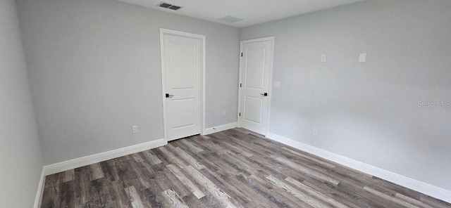 1030 Darlington Ct, Kissimmee, FL 34758 - unfurnished bedroom featuring wood finished floors and baseboards