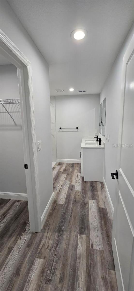 1030 Darlington Ct, Kissimmee, FL 34758 - washroom featuring wood finished floors and a sink