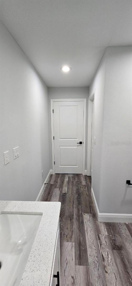 1030 Darlington Ct, Kissimmee, FL 34758 - hallway featuring dark wood-style flooring and recessed lighting