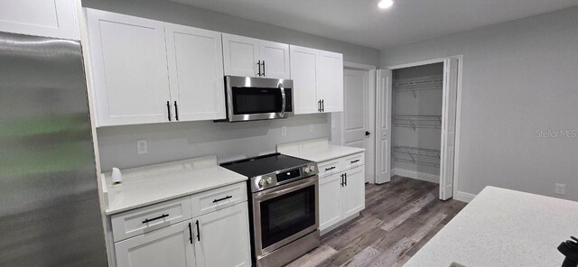 1030 Darlington Ct, Kissimmee, FL 34758 - kitchen with stainless steel appliances, light countertops, white cabinetry, and recessed lighting