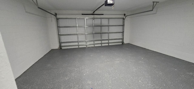 1030 Darlington Ct, Kissimmee, FL 34758 - garage with a garage door opener and concrete block wall