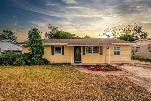 single story home featuring a yard