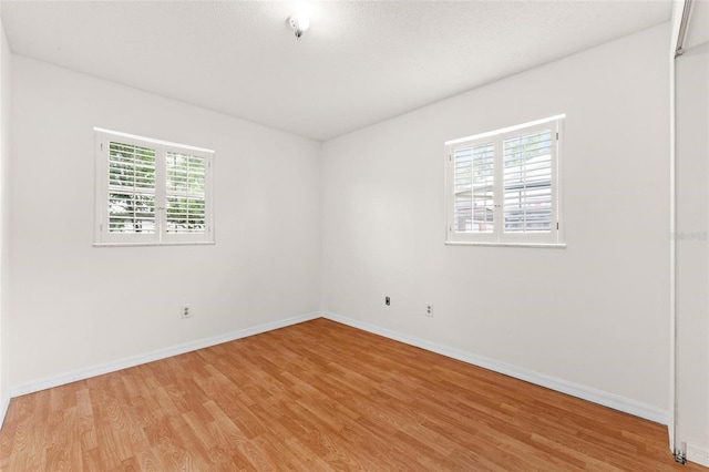 spare room with a healthy amount of sunlight and light wood-type flooring