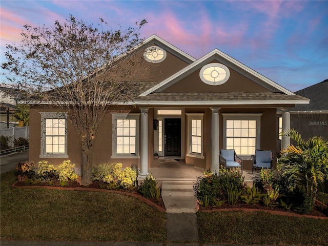 view of front of property with a yard and a porch