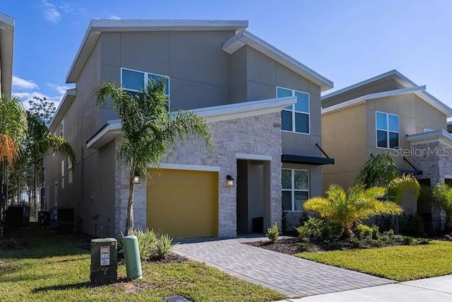 contemporary home featuring a garage and a front yard