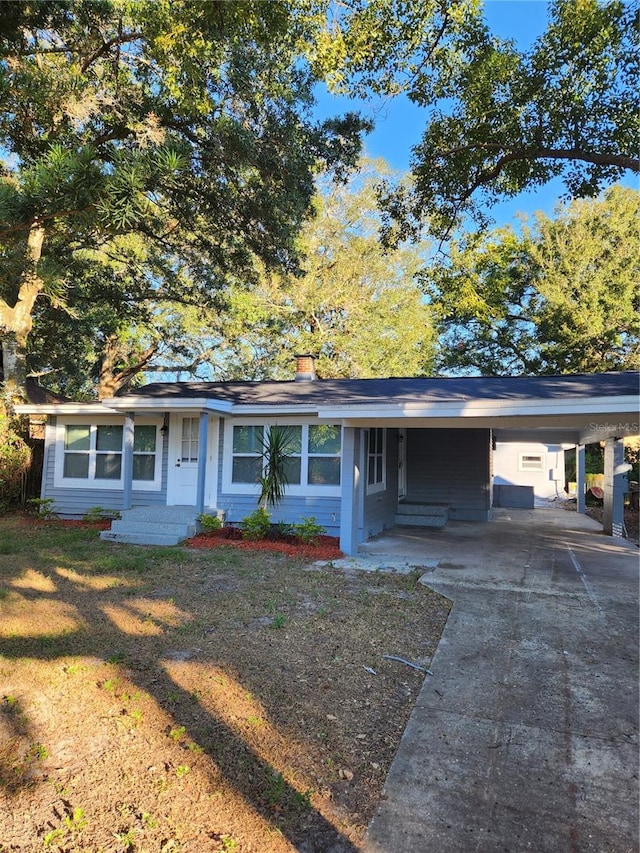 ranch-style home with a front yard and a carport