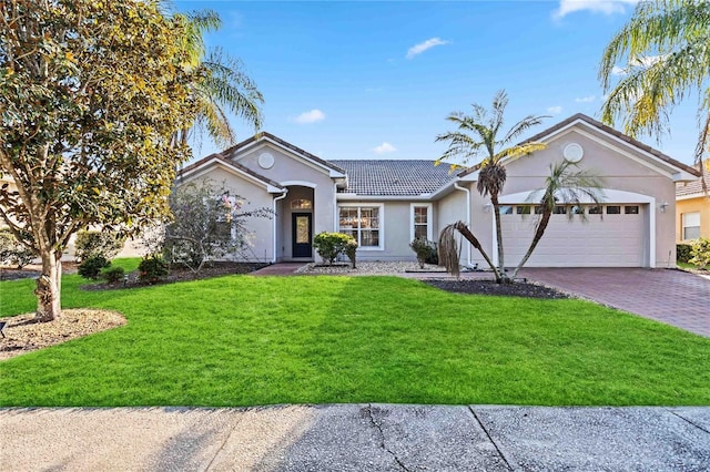 single story home with a garage and a front lawn