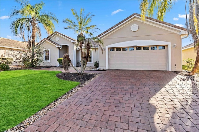 single story home with a garage and a front lawn