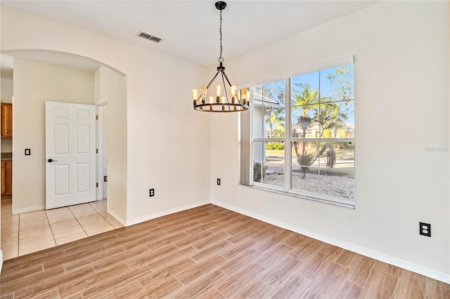 empty room with an inviting chandelier