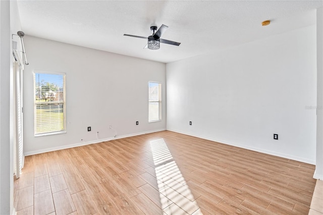 empty room with ceiling fan and a healthy amount of sunlight