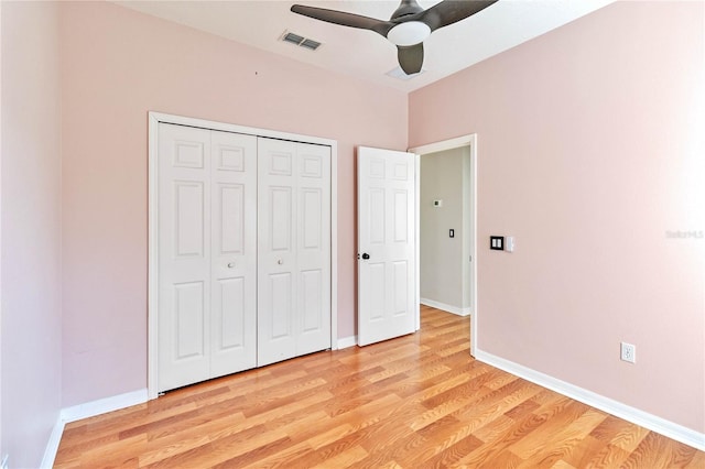 unfurnished bedroom featuring ceiling fan, light wood-type flooring, and a closet