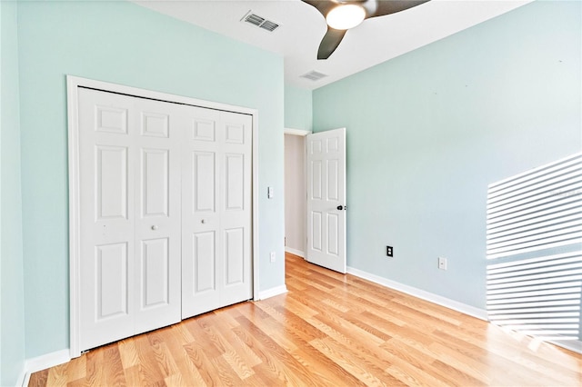 unfurnished bedroom with light wood-type flooring, a closet, and ceiling fan