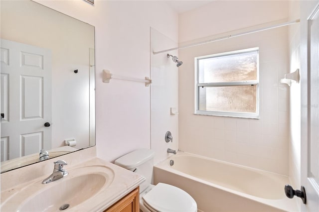 full bathroom with vanity, tiled shower / bath combo, and toilet