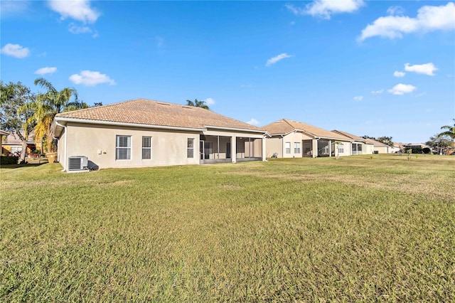 back of house with a yard, cooling unit, and a sunroom