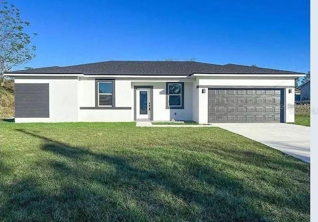 ranch-style home with a garage and a front lawn