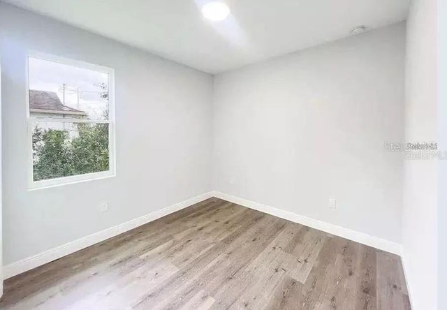 spare room featuring hardwood / wood-style floors