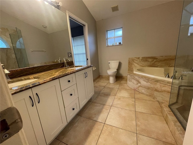 full bathroom with tile patterned flooring, separate shower and tub, vaulted ceiling, toilet, and vanity