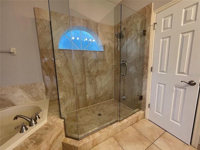 bathroom with tile patterned flooring, separate shower and tub, and vaulted ceiling