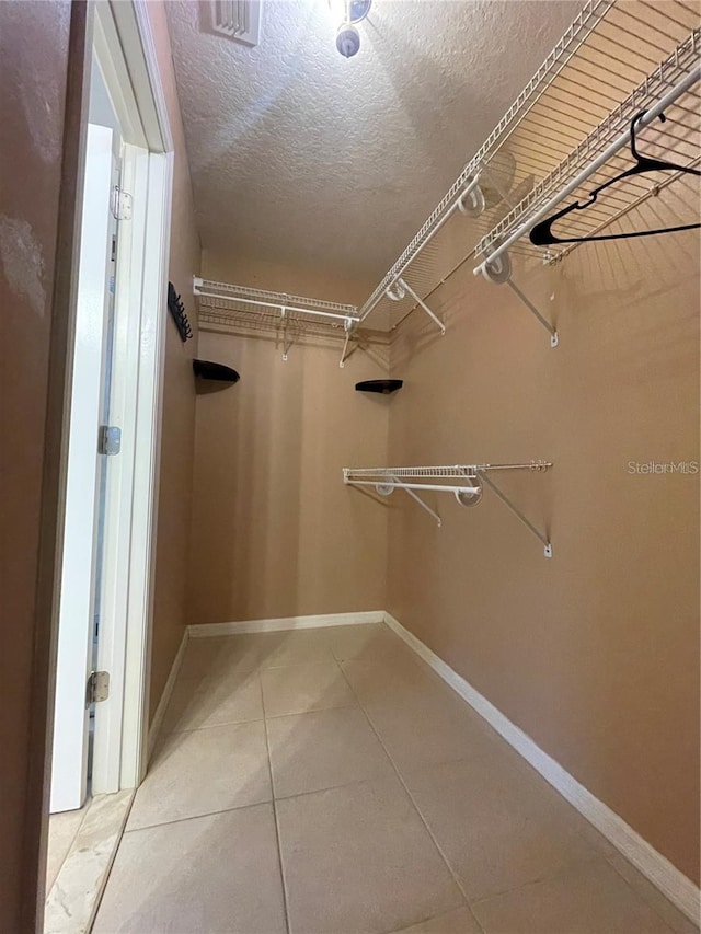 walk in closet featuring tile patterned flooring