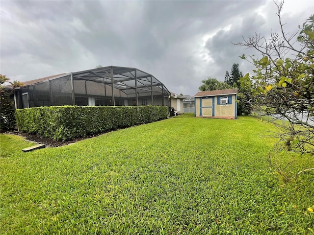 view of yard featuring a lanai and a storage shed