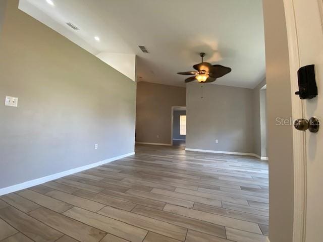 empty room with light hardwood / wood-style floors and ceiling fan