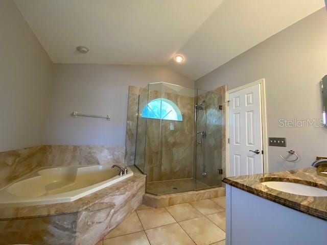 bathroom featuring tile patterned flooring, vanity, vaulted ceiling, and shower with separate bathtub