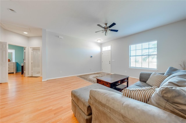 living room featuring light wood-type flooring and ceiling fan