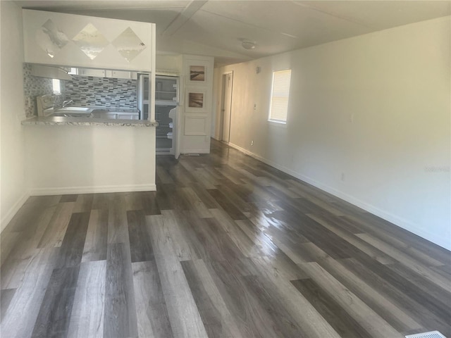 interior space with lofted ceiling and dark hardwood / wood-style floors