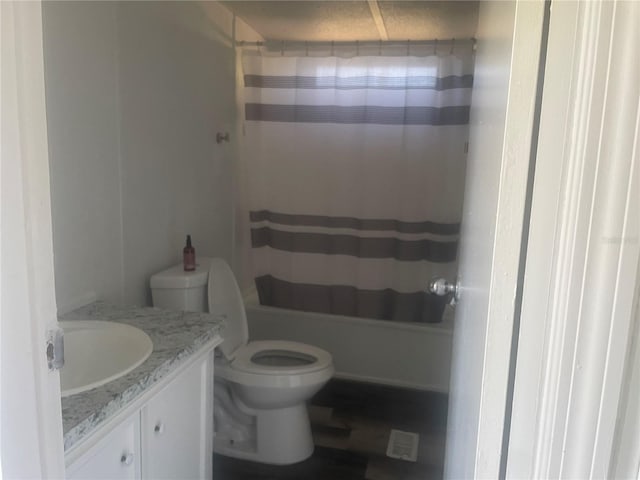 full bathroom with vanity, toilet, and shower / tub combo