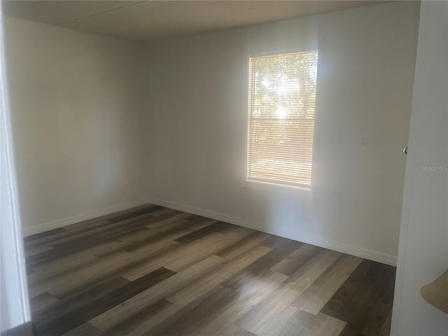 unfurnished room featuring dark hardwood / wood-style flooring