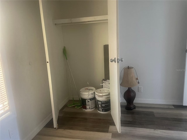 laundry area with dark hardwood / wood-style floors