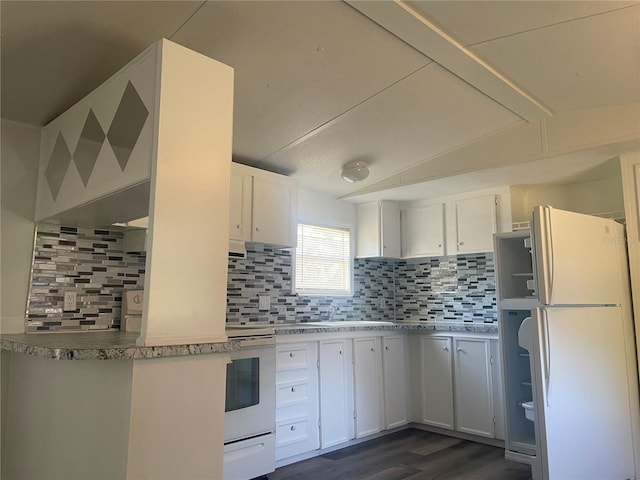 kitchen featuring white cabinets, decorative backsplash, and white fridge