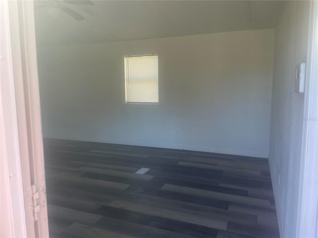 unfurnished room featuring ceiling fan and dark wood-type flooring