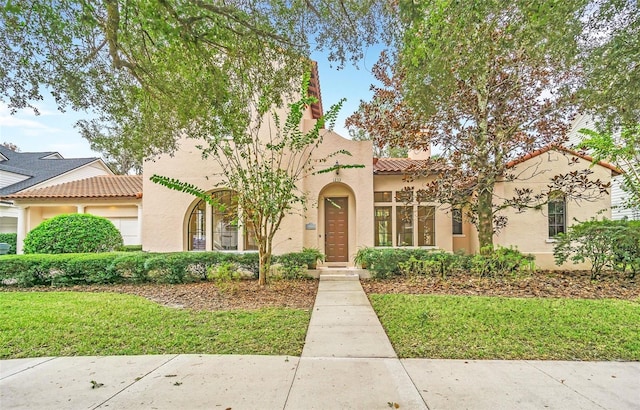1233 Aquila Loop, Celebration, FL 34747 - mediterranean / spanish house with a tile roof, stucco siding, and a front lawn
