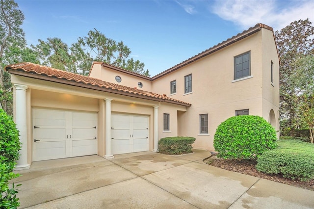 mediterranean / spanish house featuring a garage