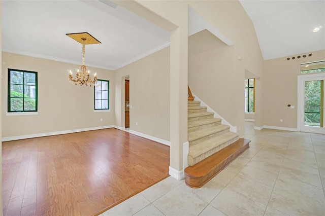1233 Aquila Loop, Celebration, FL 34747 - entrance foyer featuring a chandelier, stairway, baseboards, crown molding, and light tile patterned floors