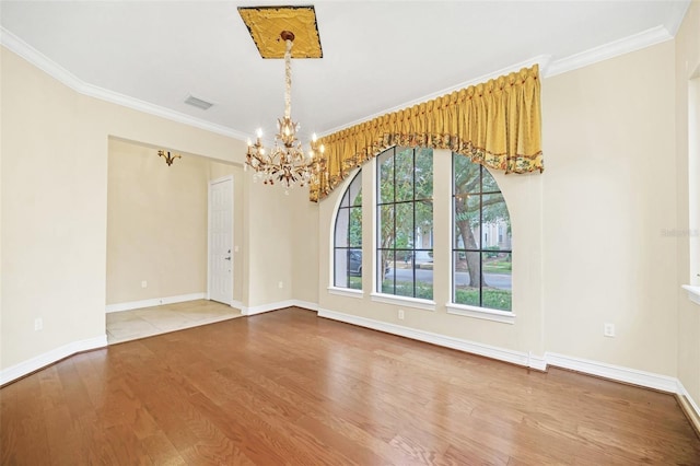 1233 Aquila Loop, Celebration, FL 34747 - empty room with wood finished floors, a chandelier, ornamental molding, and baseboards