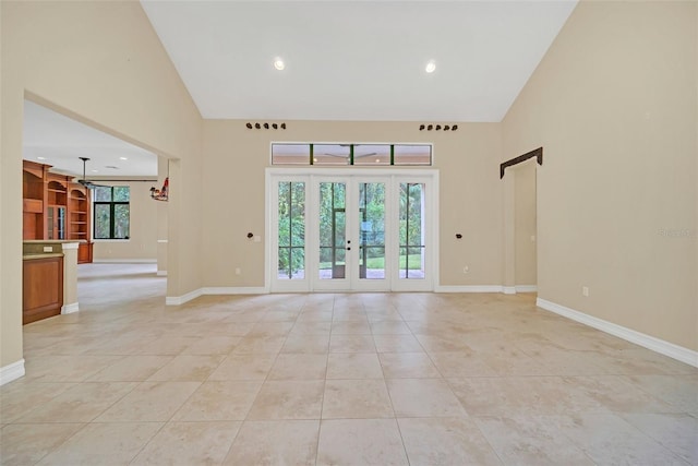 1233 Aquila Loop, Celebration, FL 34747 - unfurnished room featuring high vaulted ceiling, light tile patterned floors, french doors, baseboards, and recessed lighting