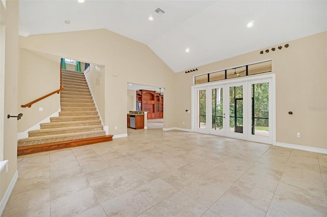 interior space with french doors, light tile patterned floors, and high vaulted ceiling