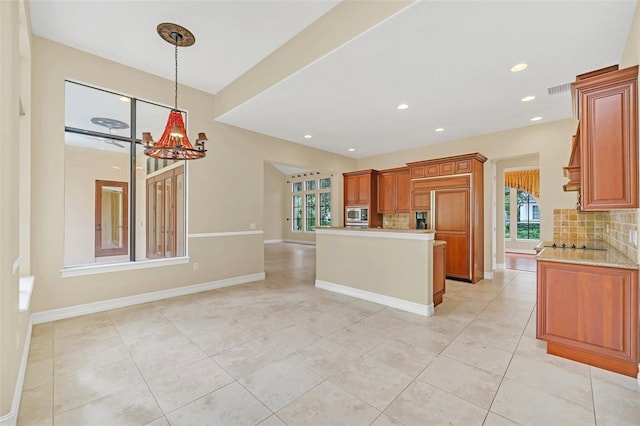 1233 Aquila Loop, Celebration, FL 34747 - kitchen featuring stainless steel microwave, backsplash, light tile patterned floors, a chandelier, and recessed lighting