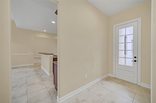 entryway with light tile patterned flooring