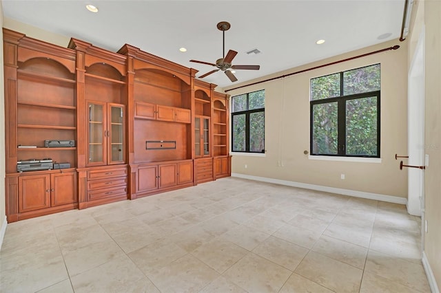 unfurnished living room featuring ceiling fan and light tile patterned floors